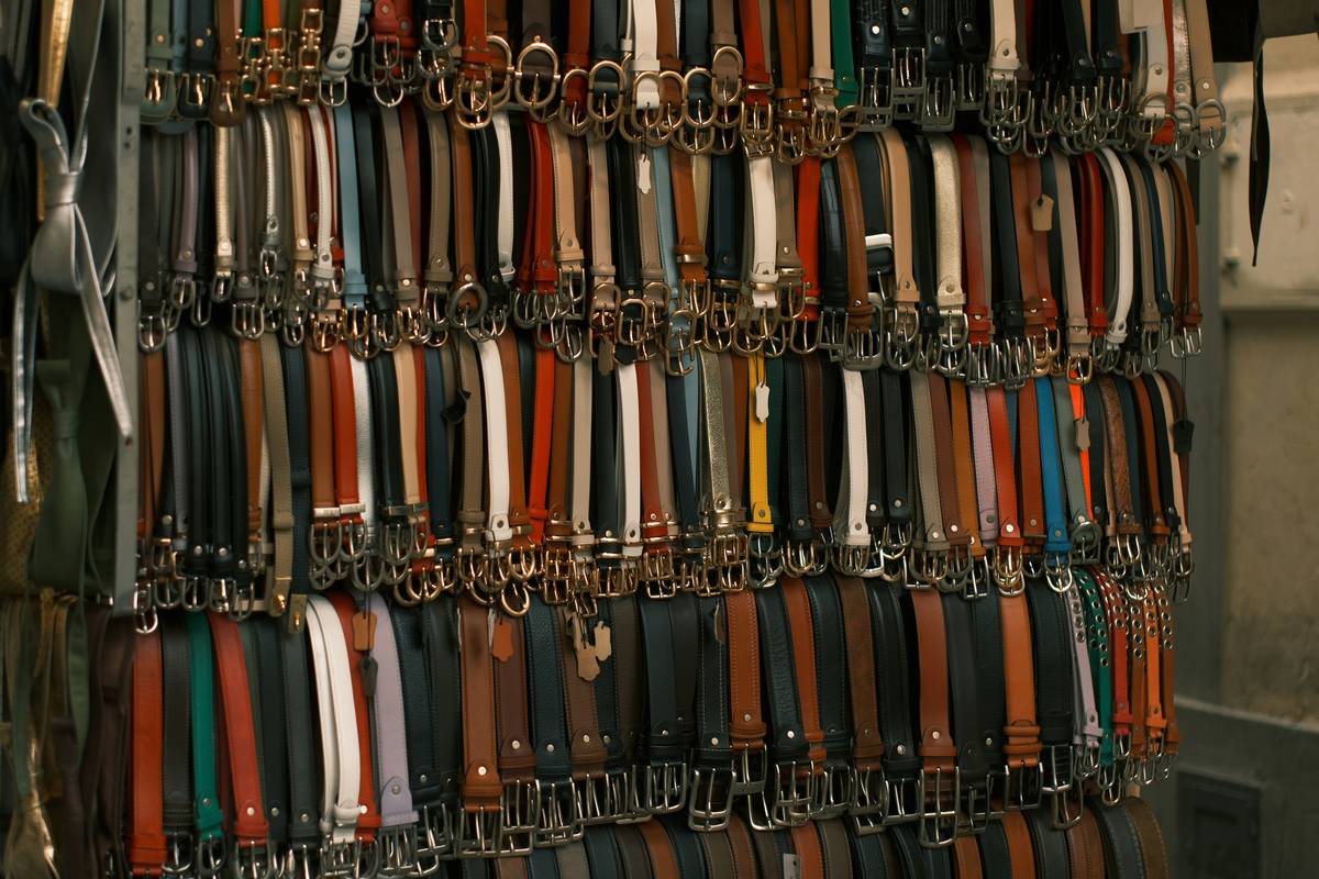 Organized v belt storage solutions with labeled hooks in dry workshop environment