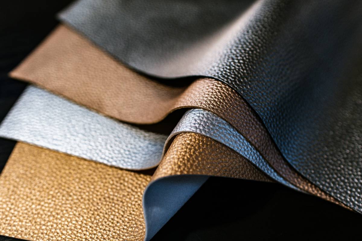 Close-up of custom leather tool belt with pouches showing stitched details and tool organization